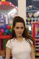 A woman standing in front of a candy store.