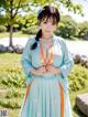 A woman in a blue and orange kimono posing for a picture.