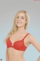 A woman in a red bra posing for a picture.