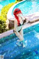 A woman in a bikini standing in a swimming pool.