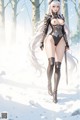 A woman in a revealing, metallic outfit stands in a snowy forest, holding a sword.