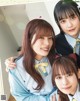 A group of young women in school uniforms posing for a picture.